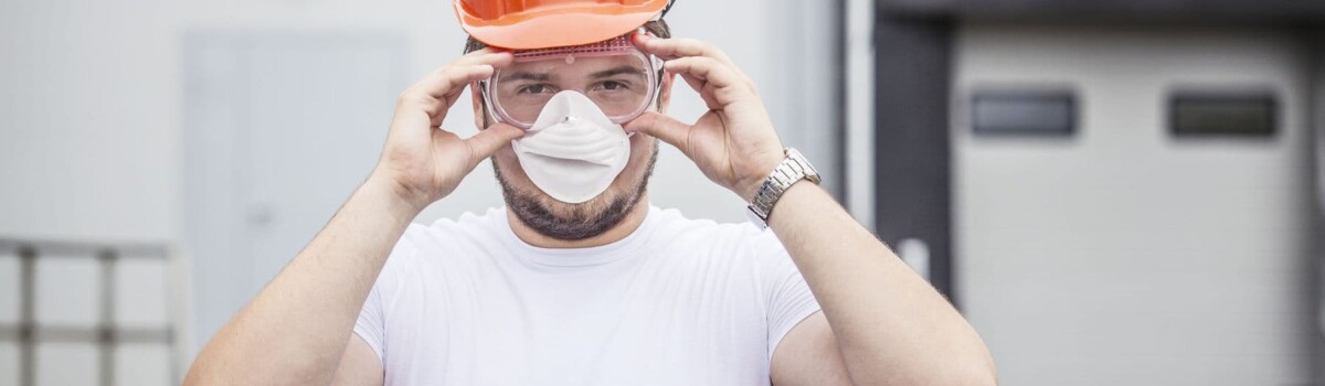 Builder putting safety glasses on