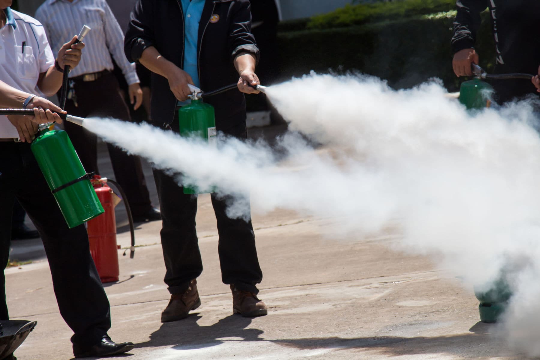 Fire safety tips Group of people being trained on how to use a fire extinguisher