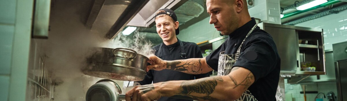 chefs preparing food in a kitchen