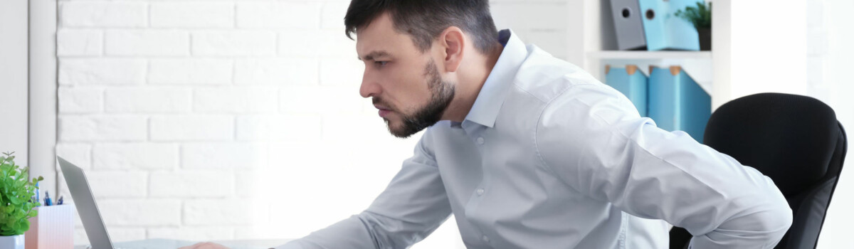 Man sitting with bad posture which will result in workplace injury