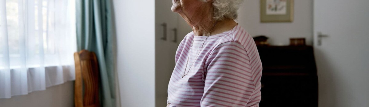 Woman living with dementia looking out of the window