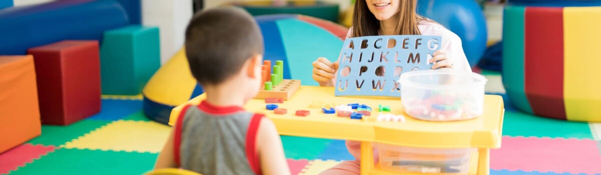 Child mental health therapist using play therapy to help young boy