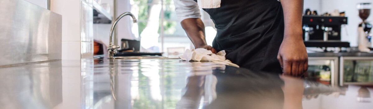 Chef using cloth to clean as you go