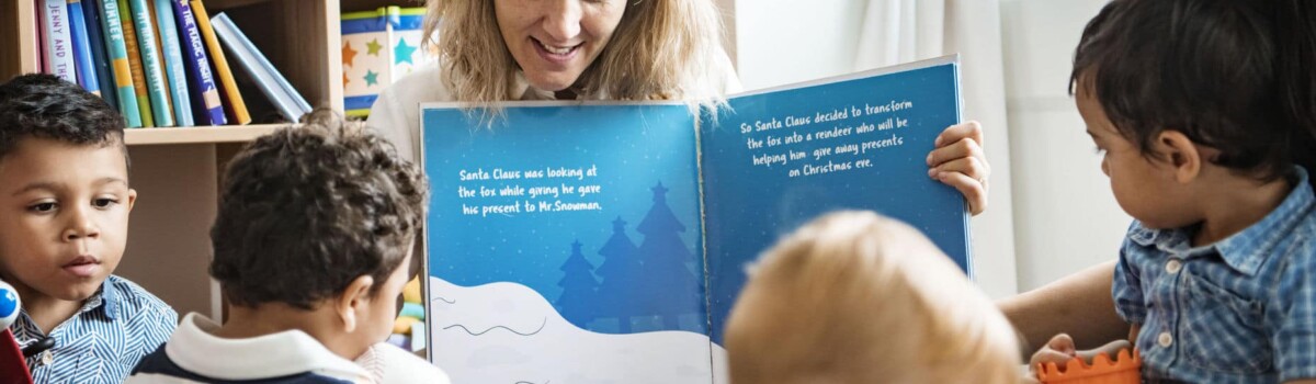 Childcare worker with children sat on the floor