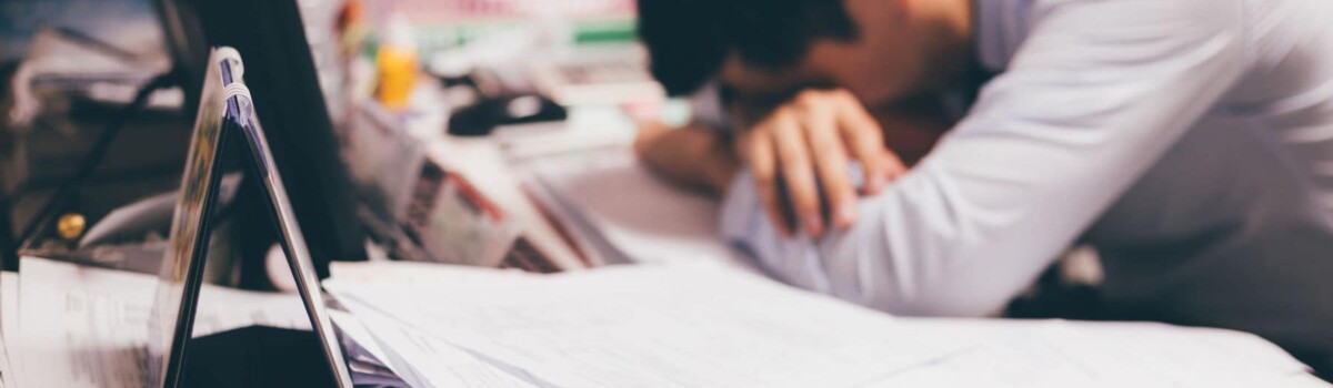 Man struggling with his mental health in the workplace