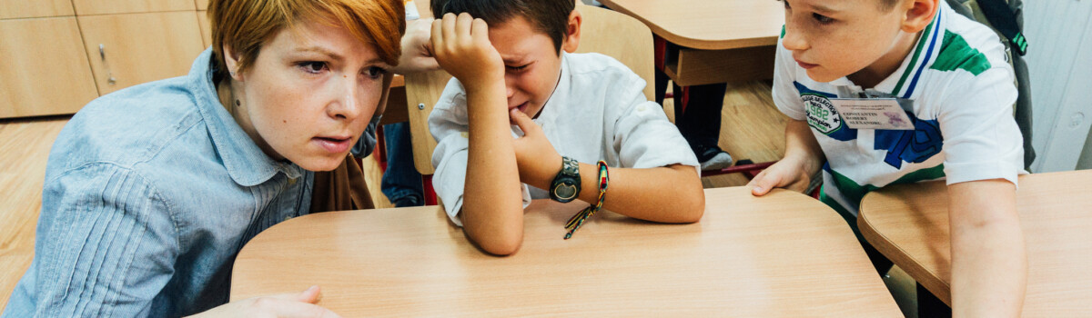 Teacher comforting student who is being bullied in school