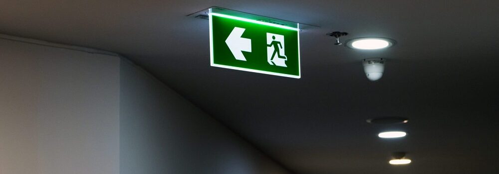 Florescent Emergency exit signs displayed in office