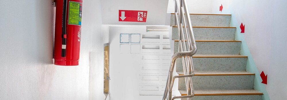 Fire exit on stairs with fluorescent signs.