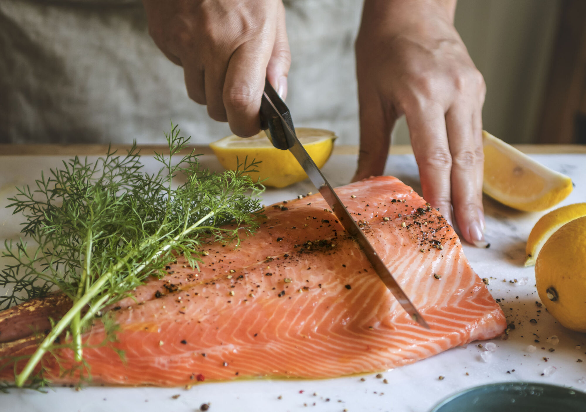 Raw fish being cut up before cooked to reduce the risk of salmonella poisoning Raw fish being cut up before cooked to reduce the risk of salmonella poisoning
