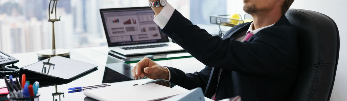 Unmotivated worker sat at his desk, after conflict in the workplace