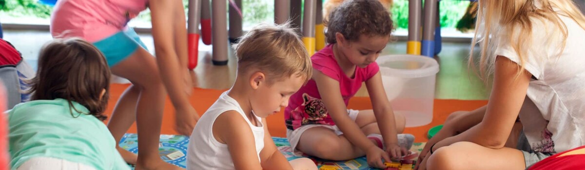 Nursery teacher showing children fire safety activities to raise their awareness