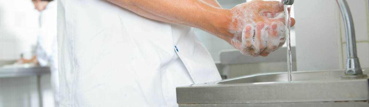 Chef in takeaway washing his hands for good hygiene practices