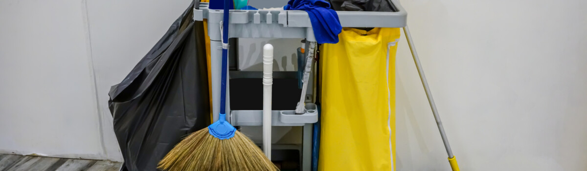 Cleaning trolley filled with cleaning products that all have COSHH labels on them