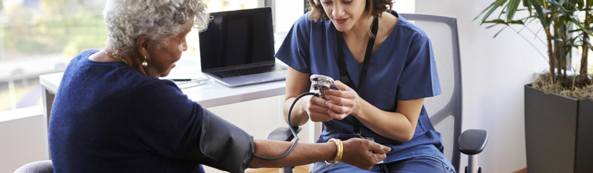 Doctor taking patients blood pressure while promoting equality