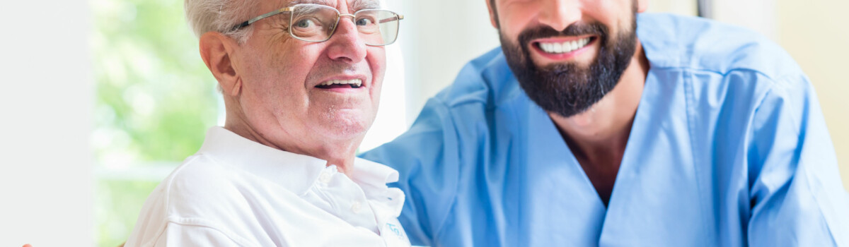 Male nurse looking after elderly patient who has had his Deprivation of Liberty removed