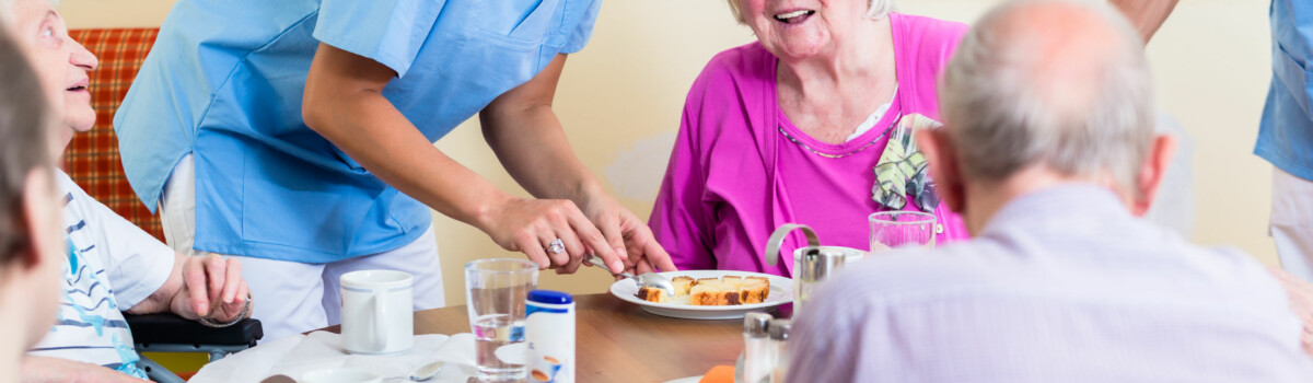 Nurse with elderly patients, ensuring their welfare is prioritised