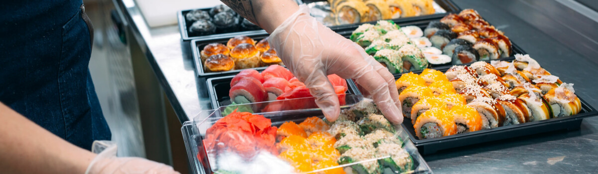 Chef in hospitality preparing food with gloves on to prevent cross contamination