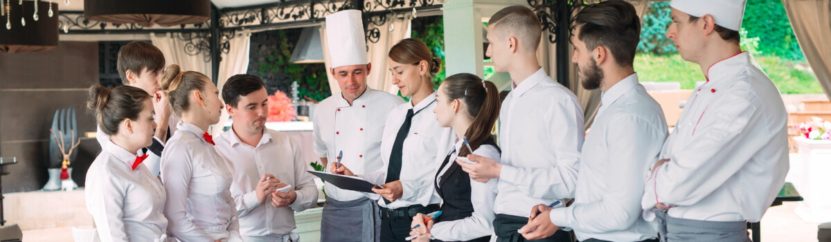 Restaurant manager and his staff reviewing their HACCP plan