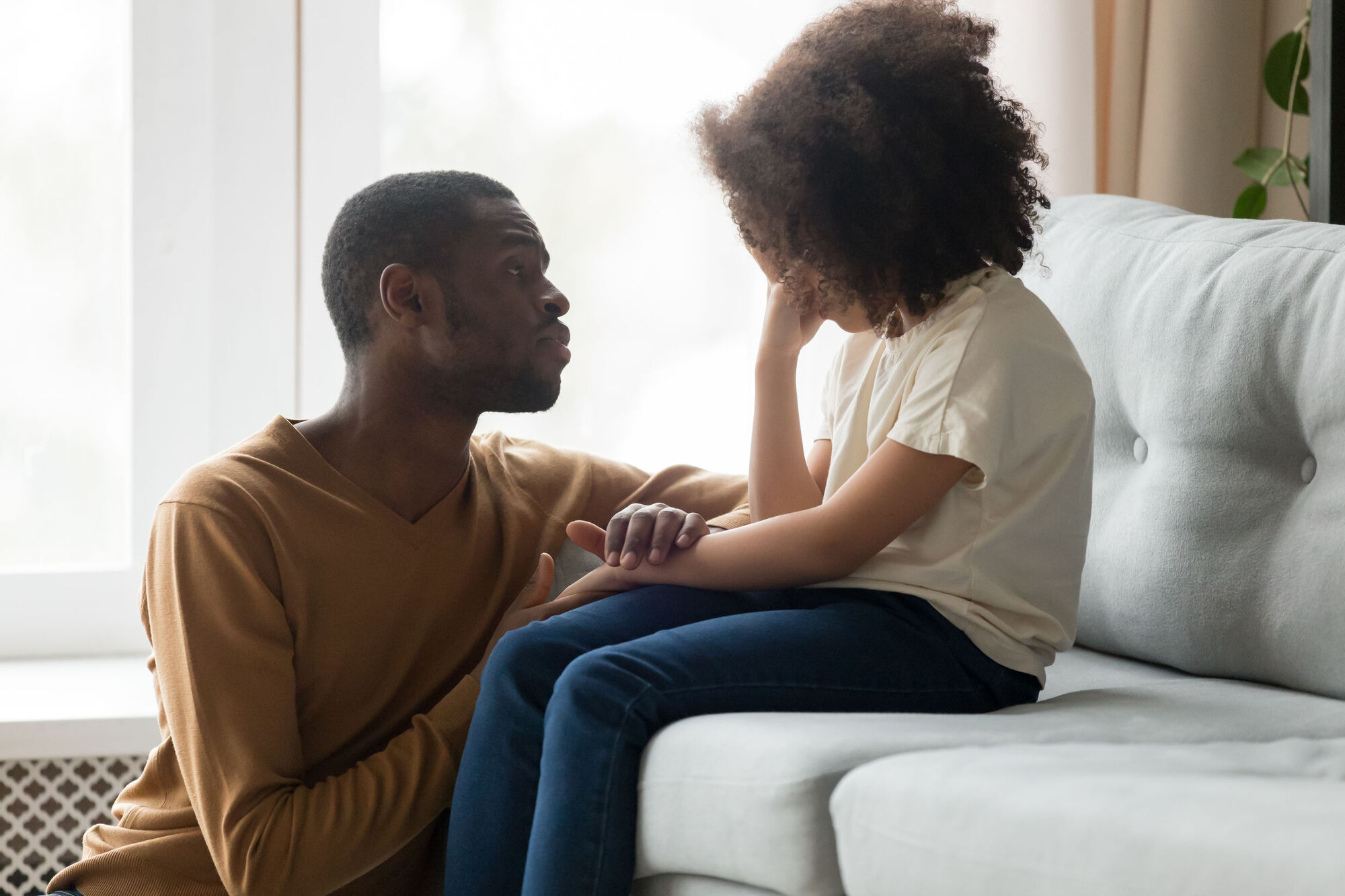 Man talking to upset child in safeguarding scenario Man talking to upset child in safeguarding scenario