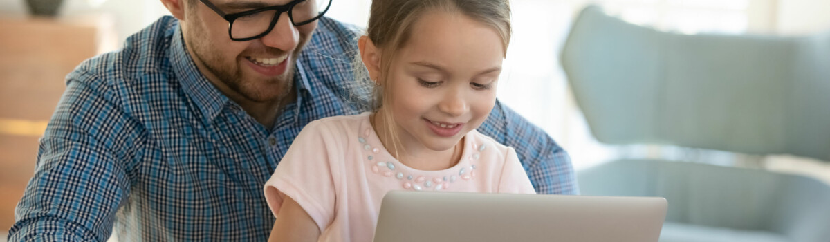 Parent Practising Facebook Safety With Child