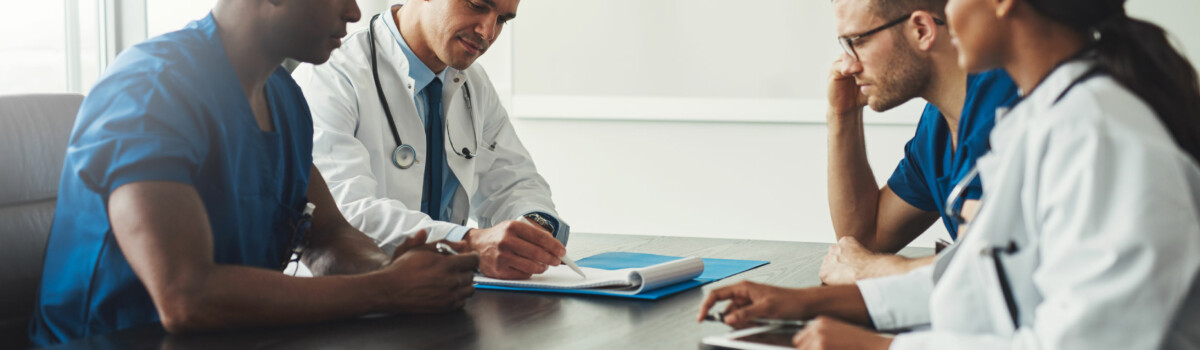 Doctors and nurses having multi-disciplinary team meeting