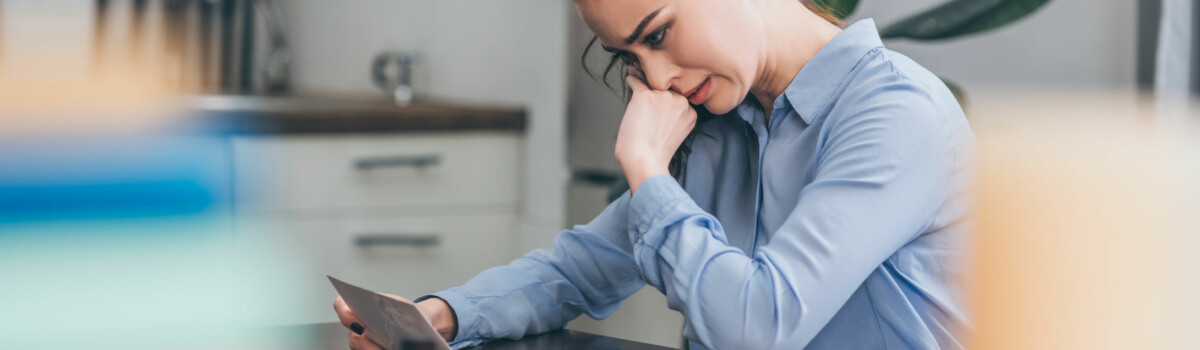 Woman struggling with bullying in the workplace upset at home