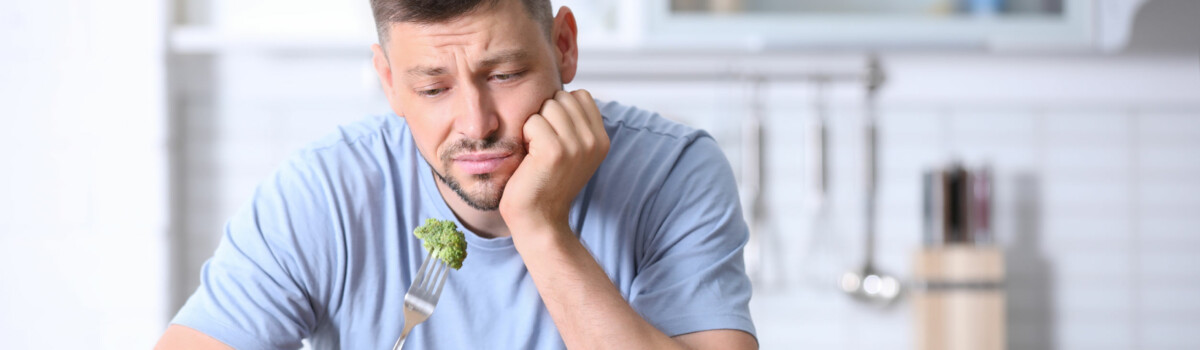 Man struggling with an eating disorder, restricting his calorie intake