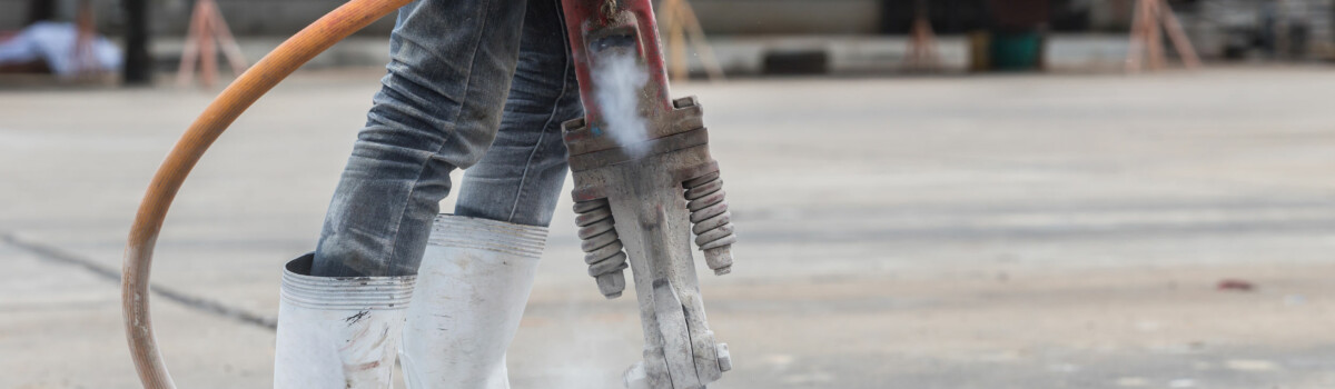 Construction worker using noisy machine equipment