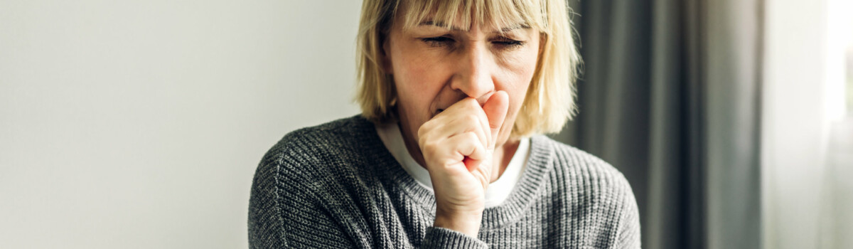 Woman coughing after being exposed to asbestos for years