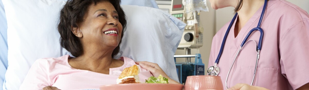 Nurse serving food to vulnerable patient in hospital