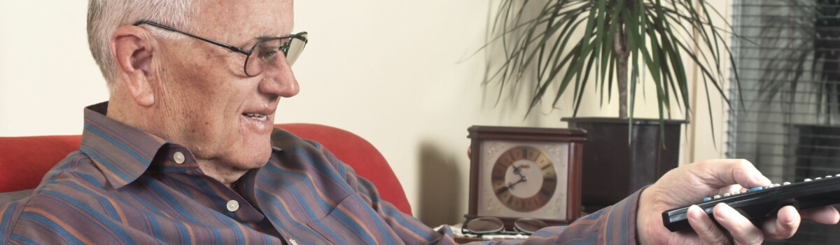 Man with dementia sat relaxing in nursing home