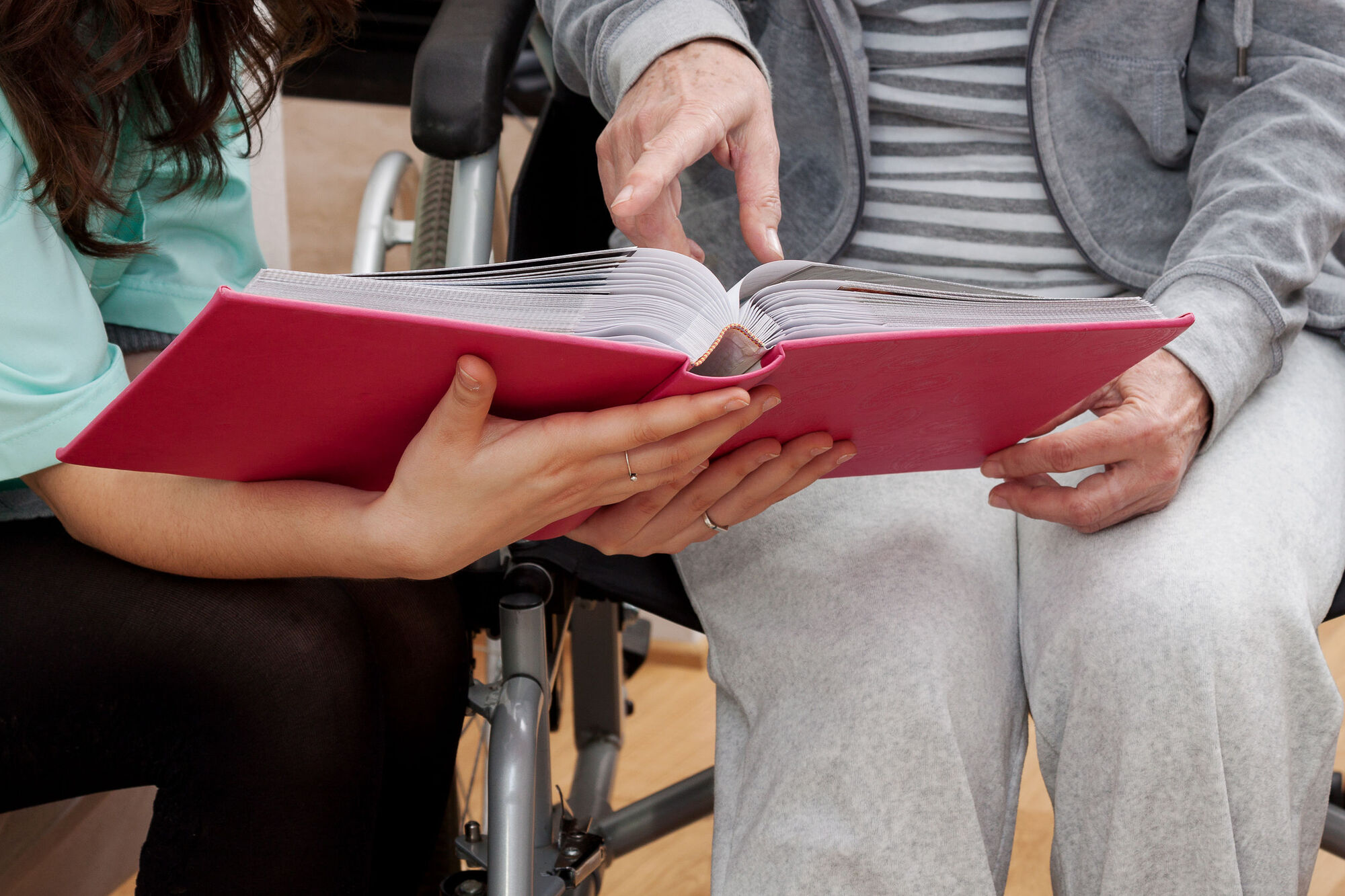 Volunteer reading to disabled service user Volunteer reading to disabled service user