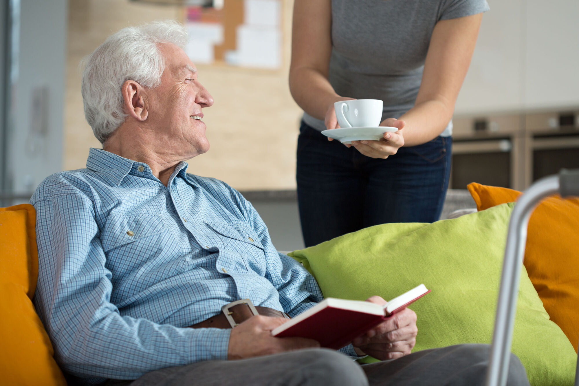 Volunteer in care home providing resident with a hot drink Volunteer in care home providing resident with a hot drink