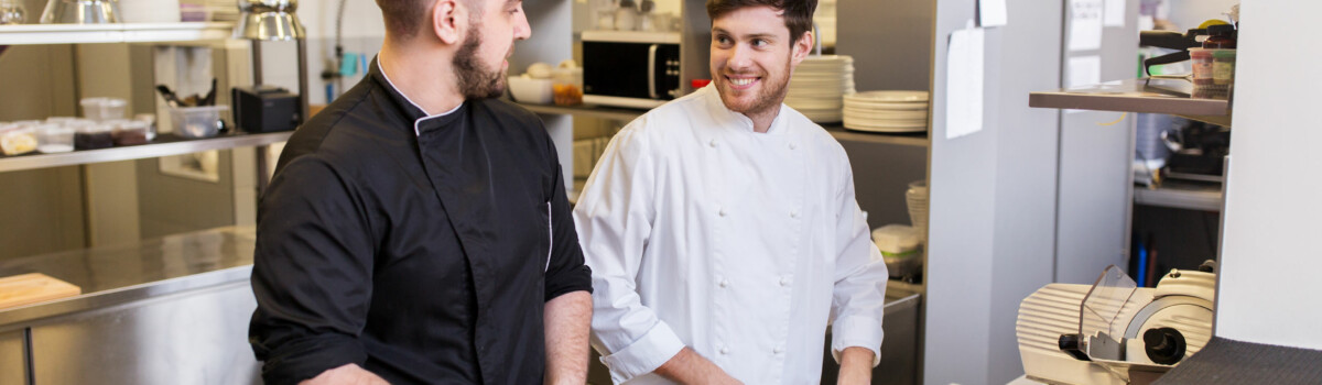 Chefs prepping food discussing when to complete their stocktake