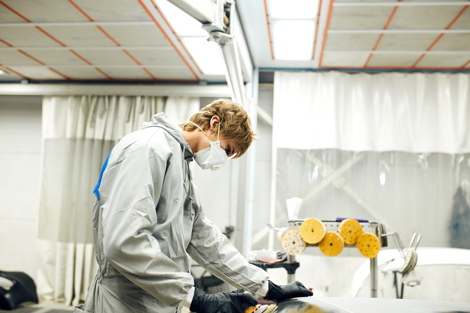 Woman wearing a mask in a workshop Woman wearing a mask in a workshop