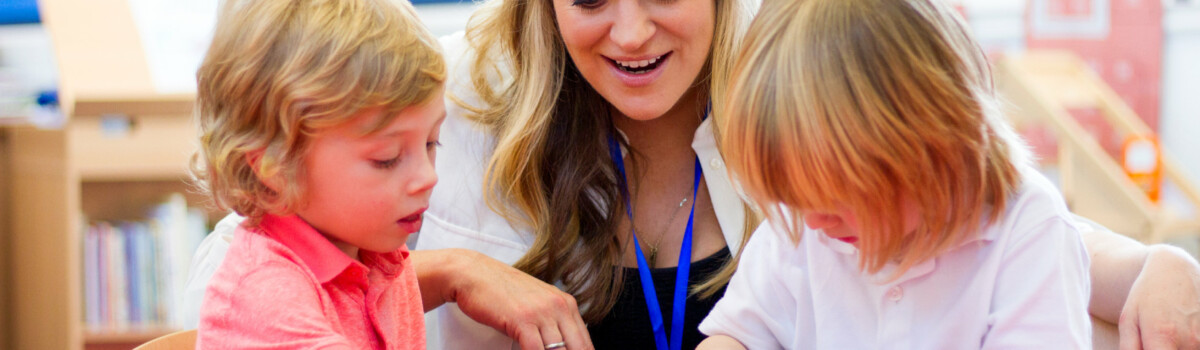 Teacher sat with children who have ADHD playing