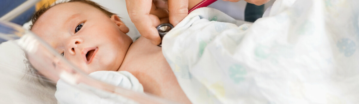 Midwife examining new born baby