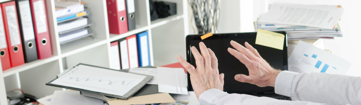 Business man has a messy desk due to hoarding