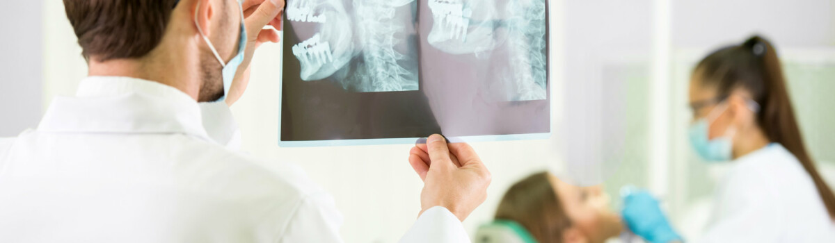 Dentist examining x-rays