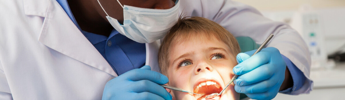 Dentist working with child