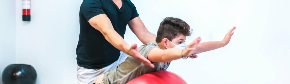 Physiotherapist working in school with young child