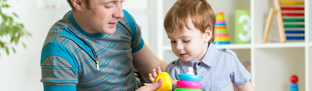 Man playing with young child