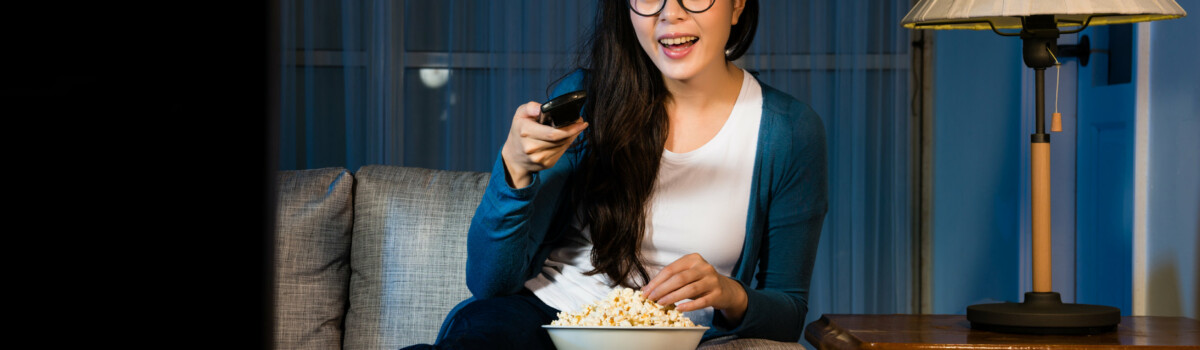 A woman watching tv to feel distracted