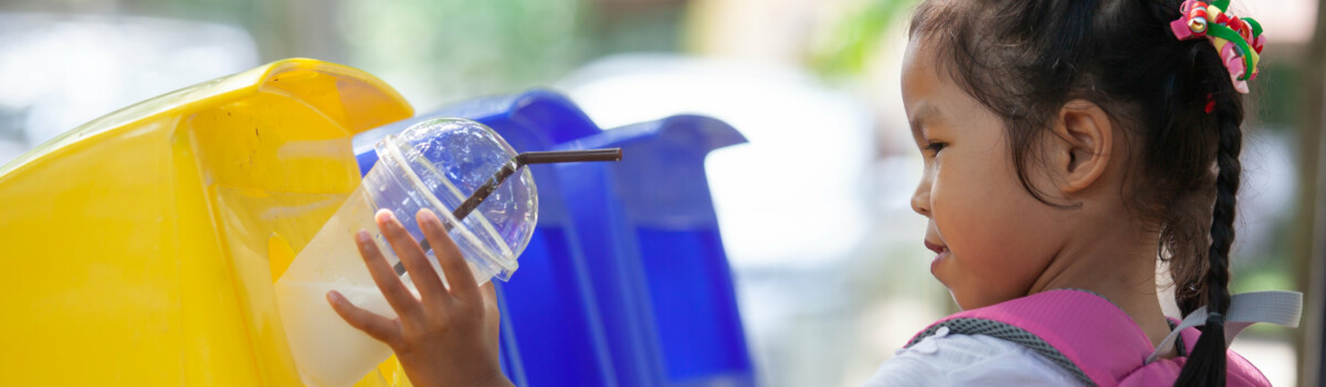 Young girl recycling in school