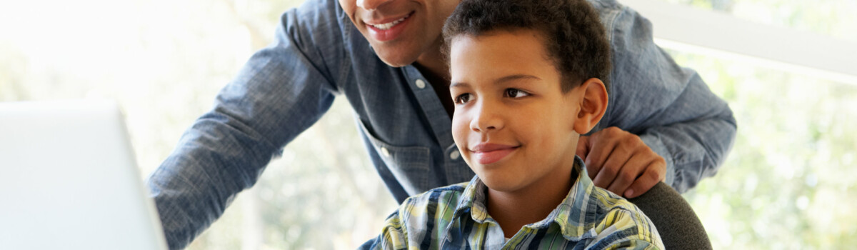 Parent helping child learn online