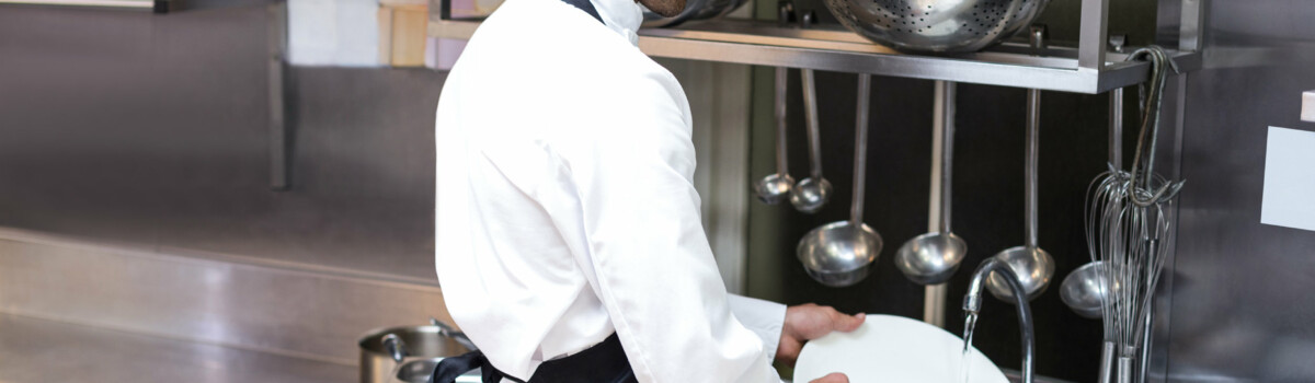 Man washing dishes in a restaurant