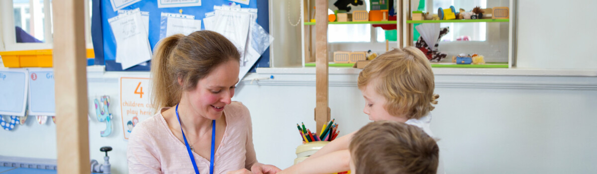 Teacher volunteering at out of school club