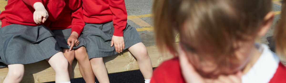 A young girl being bullied by her peers