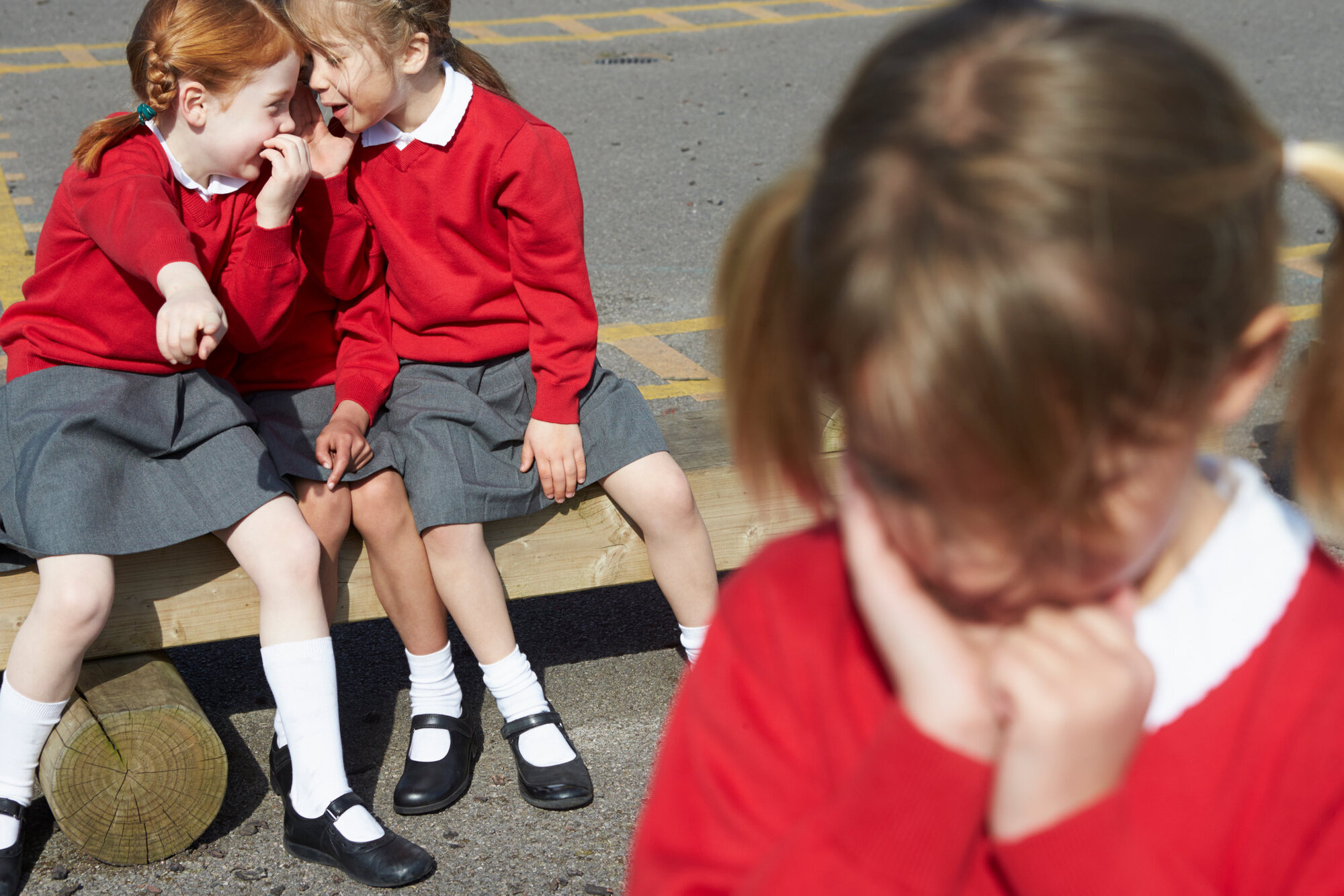 A young girl being bullied by her peers A young girl being bullied by her peers