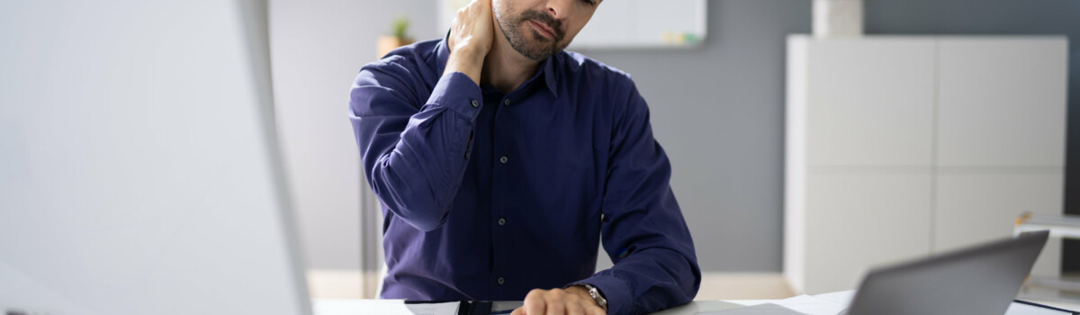 Businessman with neck pain from computer